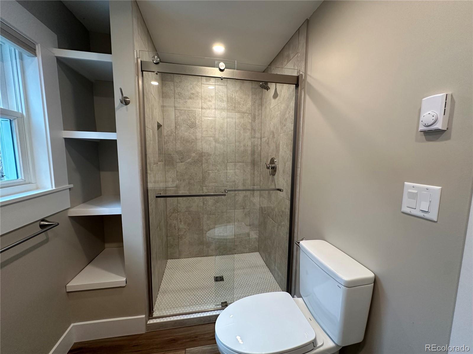 906 Main Street Georgetown, CO 80444 - Photo 20 of 28 a bathroom with a shower a toilet and a sink