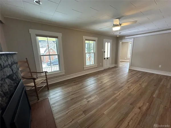 wooden floor in an empty room with a window