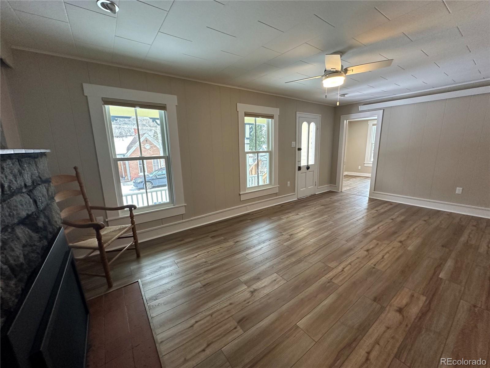 906 Main Street Georgetown, CO 80444 - Photo 3 of 28 wooden floor in an empty room with a window