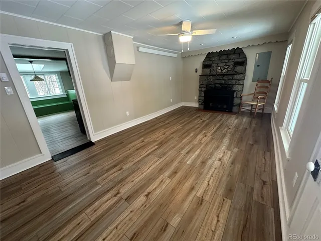 a view of empty room with wooden floor