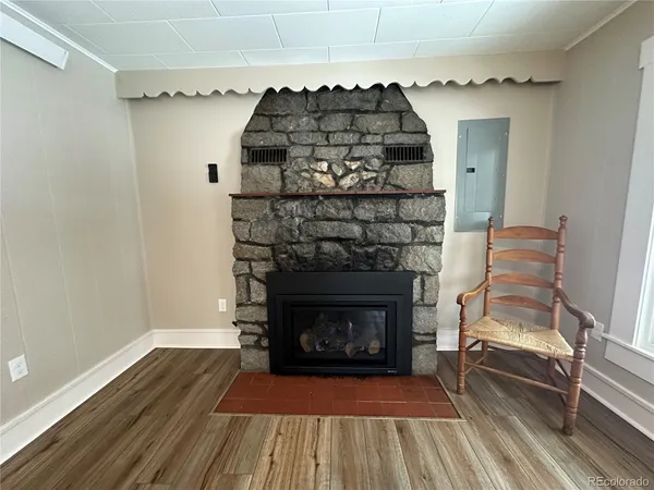 a room with fireplace and a wooden floor