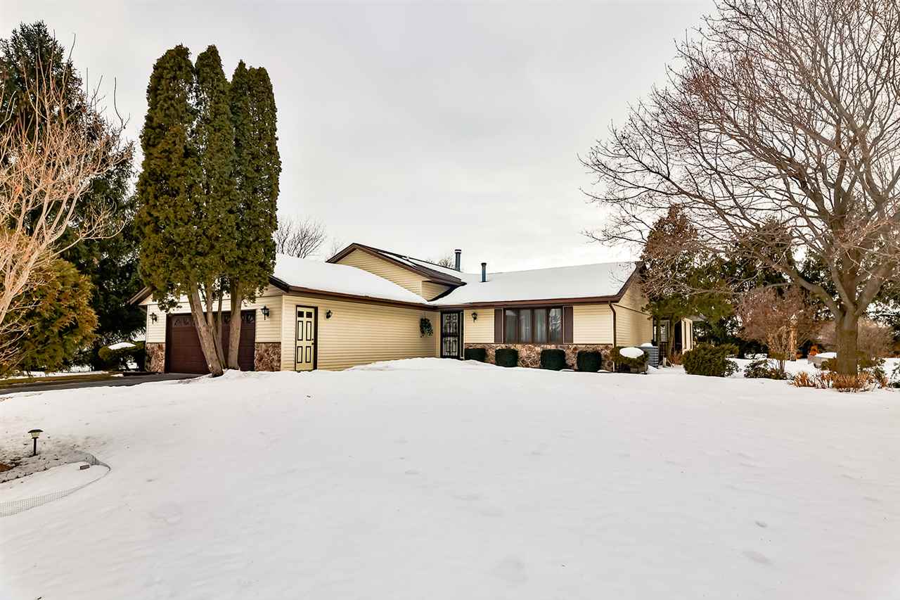 12944 Huntsboro Lane Roscoe, IL 61073 - Photo 1 of 40 a front view of a house with a snow in front of yard