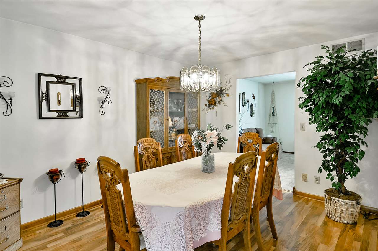 12944 Huntsboro Lane Roscoe, IL 61073 - Photo 16 of 40 a view of a dining room with furniture and chandelier