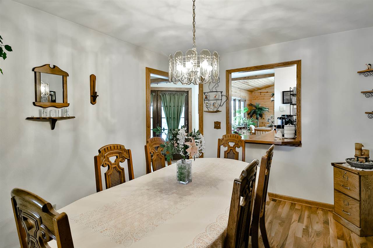 12944 Huntsboro Lane Roscoe, IL 61073 - Photo 17 of 40 a view of a dining room with furniture and chandelier