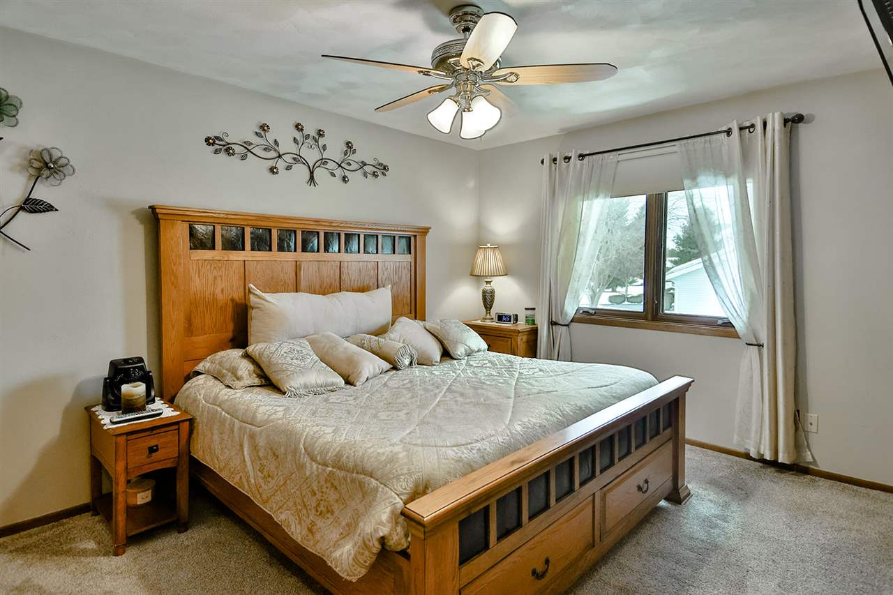 12944 Huntsboro Lane Roscoe, IL 61073 - Photo 19 of 40 a bed room with a bed and a chandelier