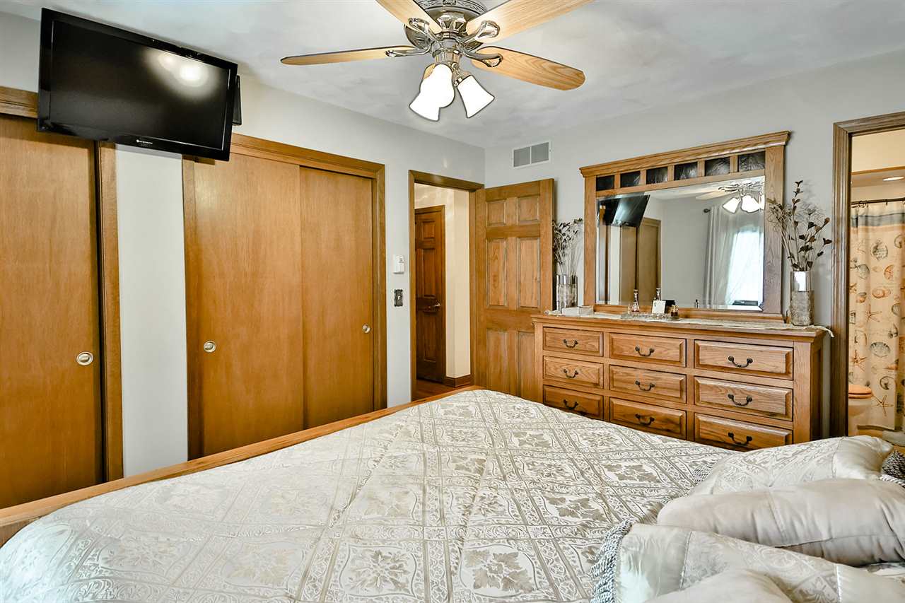 12944 Huntsboro Lane Roscoe, IL 61073 - Photo 20 of 40 a bedroom with a bed and a chandelier