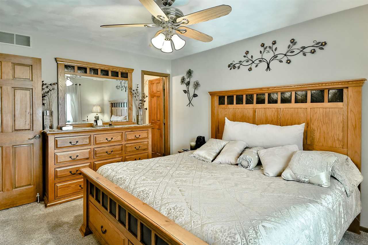 12944 Huntsboro Lane Roscoe, IL 61073 - Photo 21 of 40 a bedroom with a bed and a chandelier