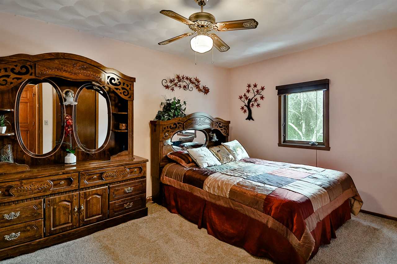 12944 Huntsboro Lane Roscoe, IL 61073 - Photo 23 of 40 a bedroom with bed and a mirror