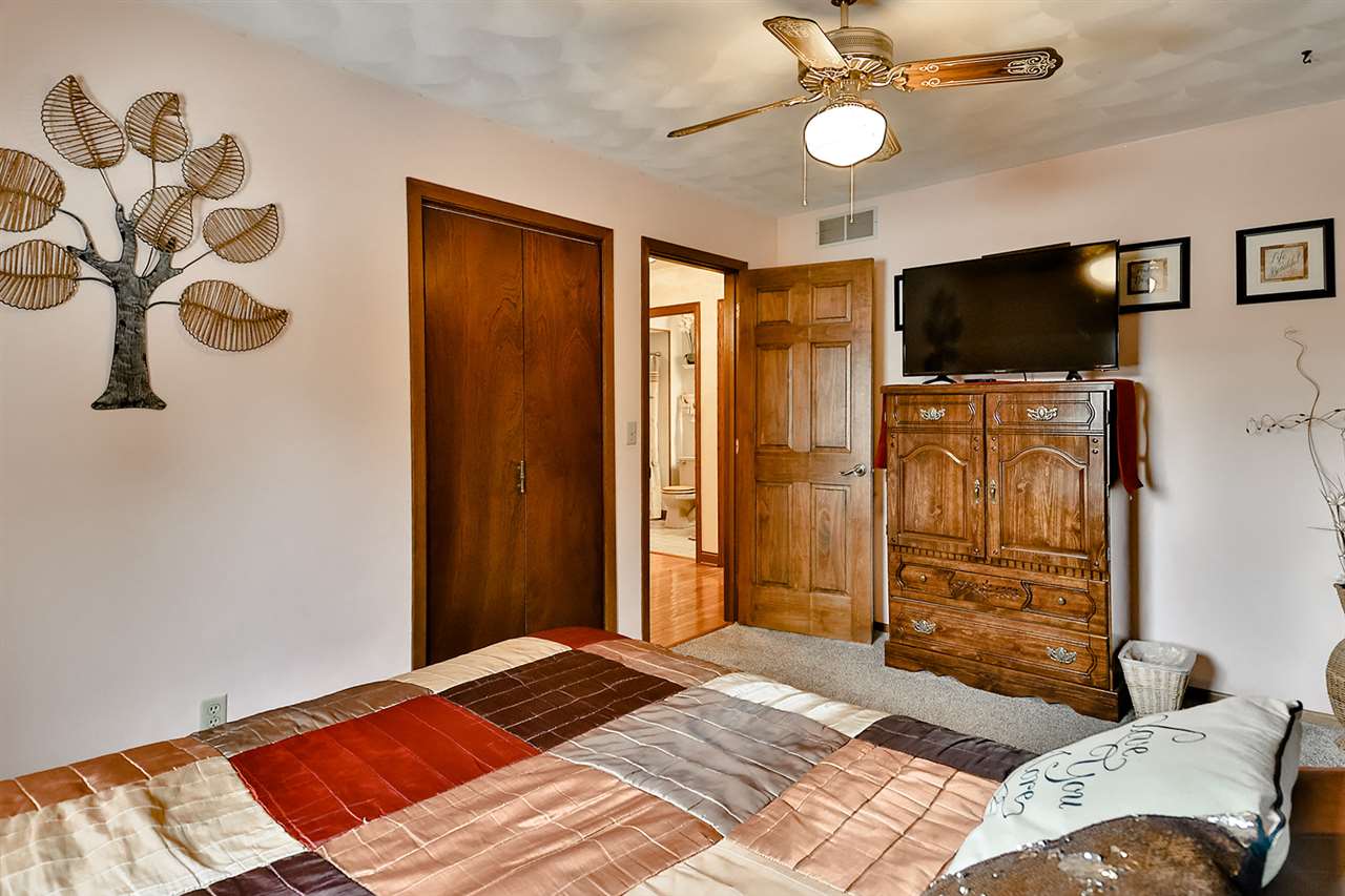 12944 Huntsboro Lane Roscoe, IL 61073 - Photo 26 of 40 a bedroom with a bed and a flat screen tv