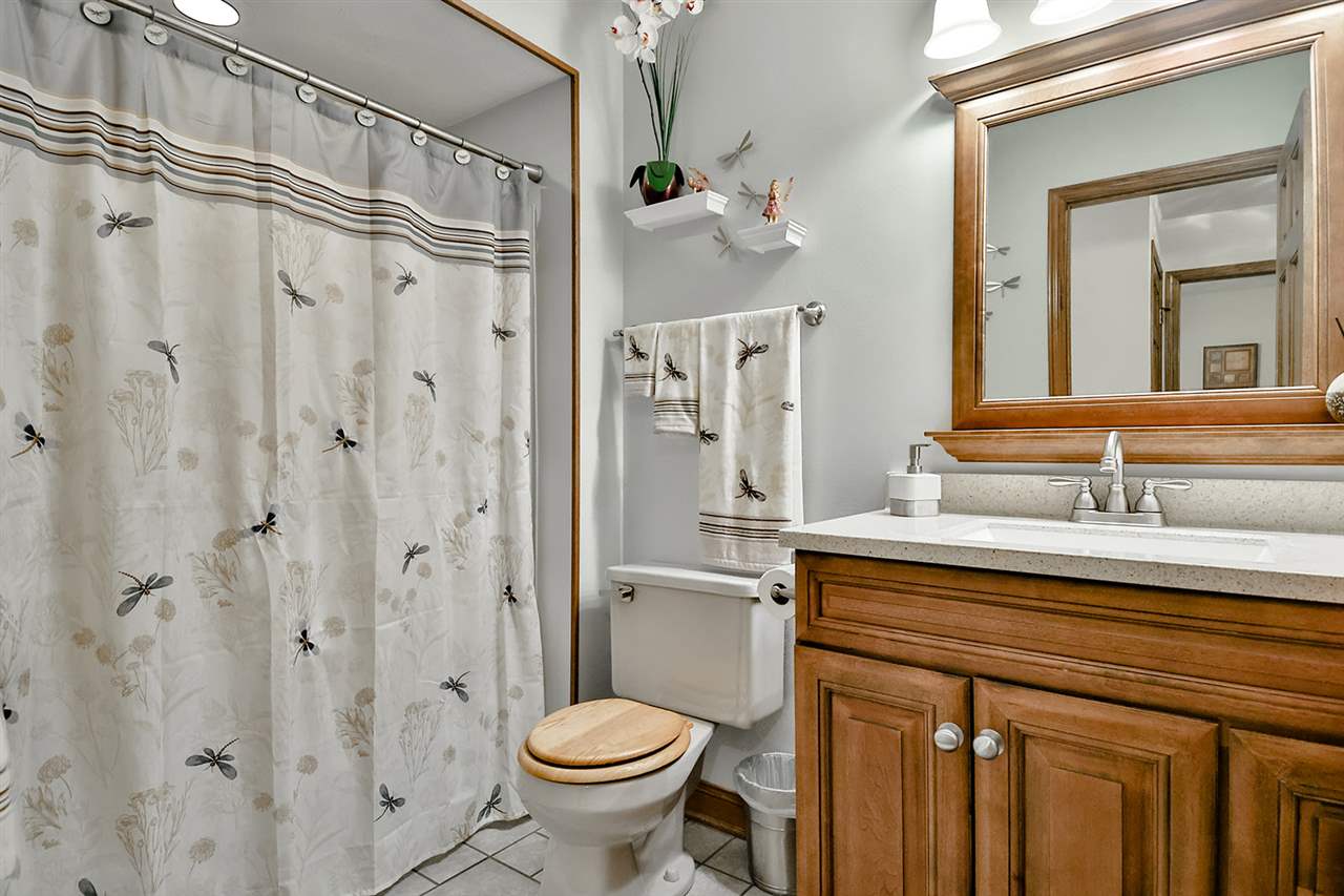12944 Huntsboro Lane Roscoe, IL 61073 - Photo 27 of 40 a bathroom with a granite countertop sink toilet and shower