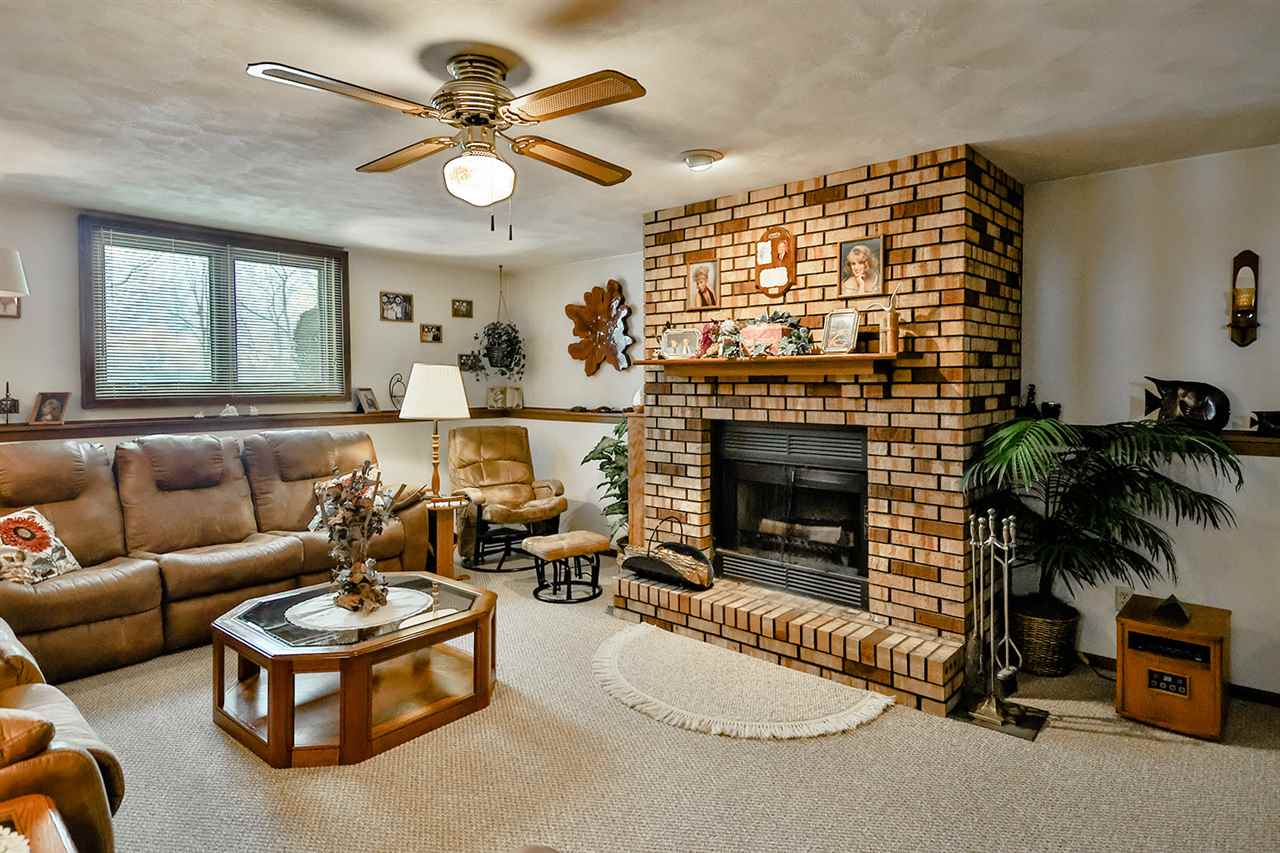12944 Huntsboro Lane Roscoe, IL 61073 - Photo 28 of 40 a living room with furniture and a fireplace