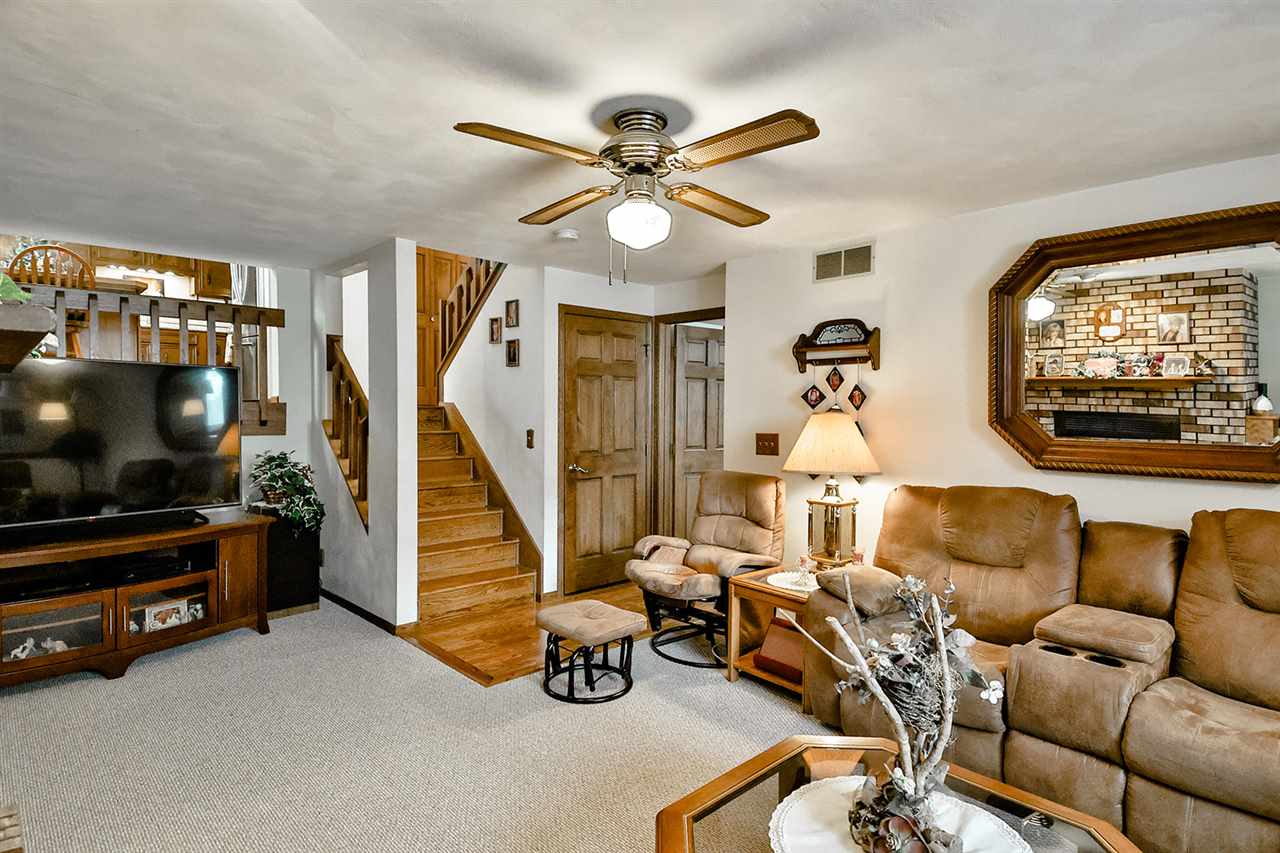 12944 Huntsboro Lane Roscoe, IL 61073 - Photo 30 of 40 a living room with furniture and a flat screen tv