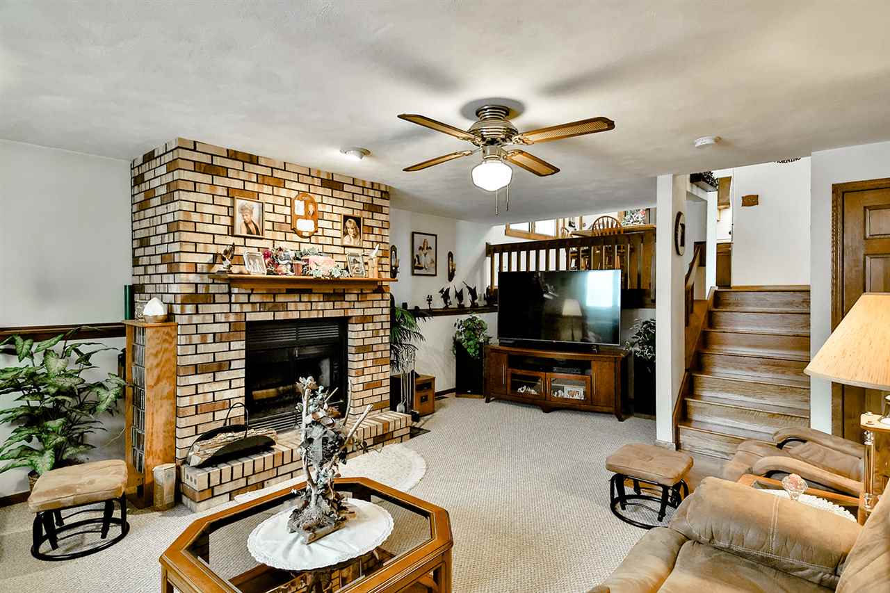 12944 Huntsboro Lane Roscoe, IL 61073 - Photo 31 of 40 a living room with furniture and a fireplace