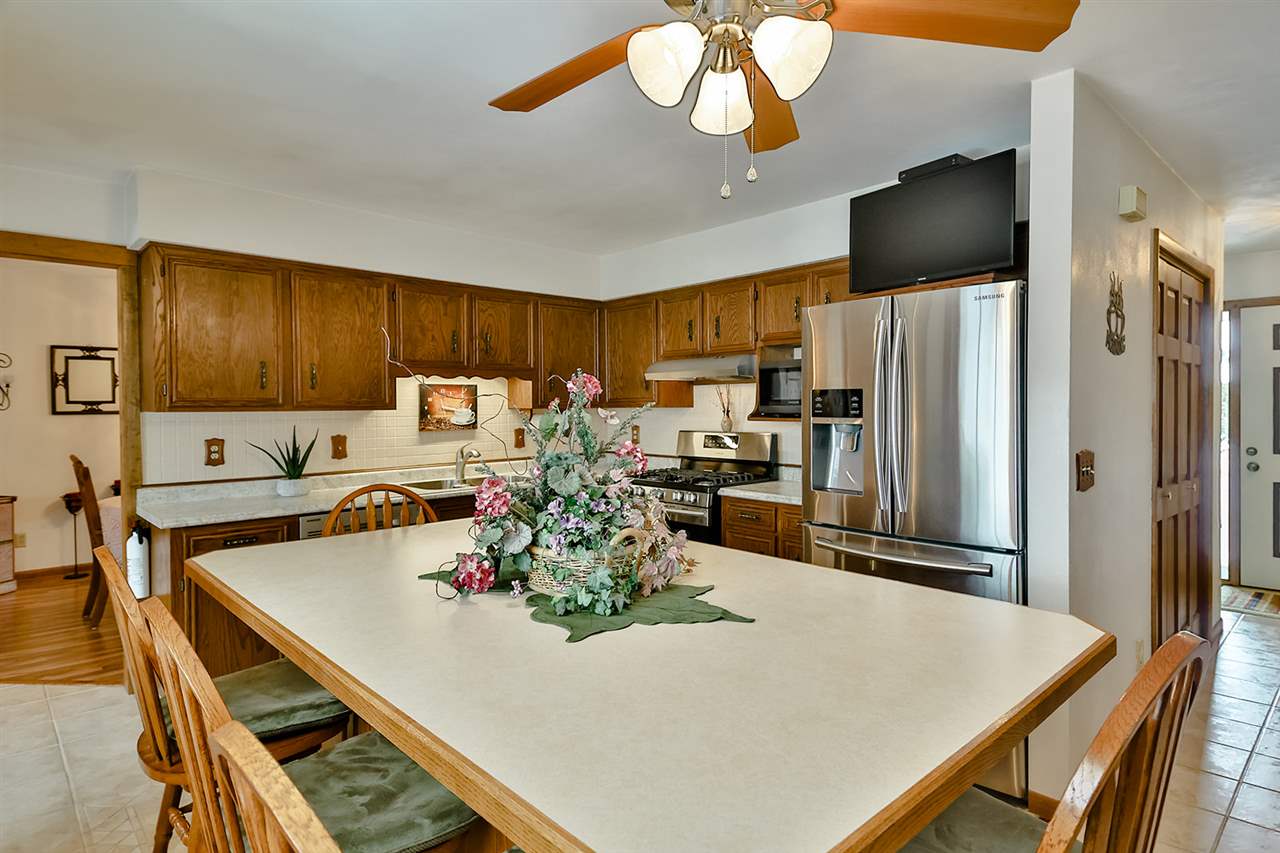12944 Huntsboro Lane Roscoe, IL 61073 - Photo 10 of 40 a kitchen with a dining table cabinets and stainless steel appliances