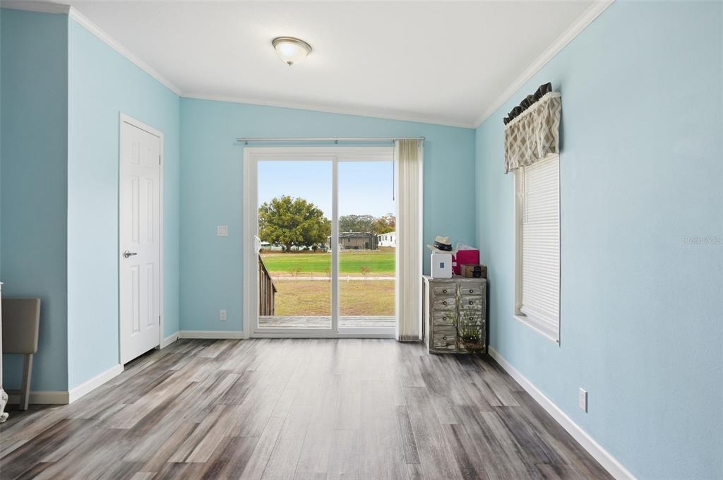 9100 Highpoint Boulevard Brooksville, FL 34613 - Photo 12 of 42 a view of empty room with wooden floor and fan