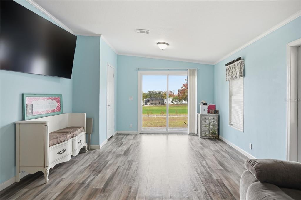 9100 Highpoint Boulevard Brooksville, FL 34613 - Photo 13 of 42 a room with furniture and a flat screen tv