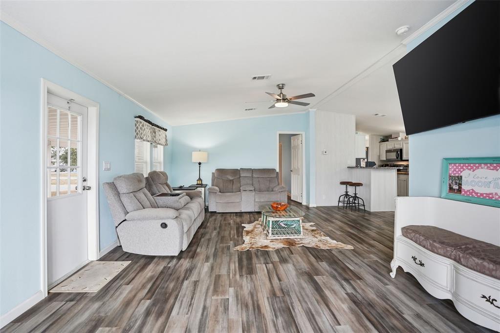 9100 Highpoint Boulevard Brooksville, FL 34613 - Photo 14 of 42 a living room with furniture and a flat screen tv