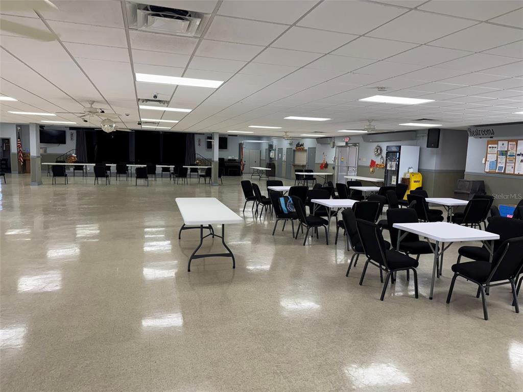 9100 Highpoint Boulevard Brooksville, FL 34613 - Photo 33 of 42 a view of a dining area with lots of furniture and chandelier