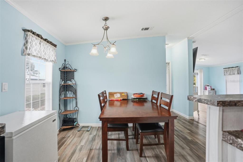 9100 Highpoint Boulevard Brooksville, FL 34613 - Photo 6 of 42 a view of a dining room with furniture window and wooden floor