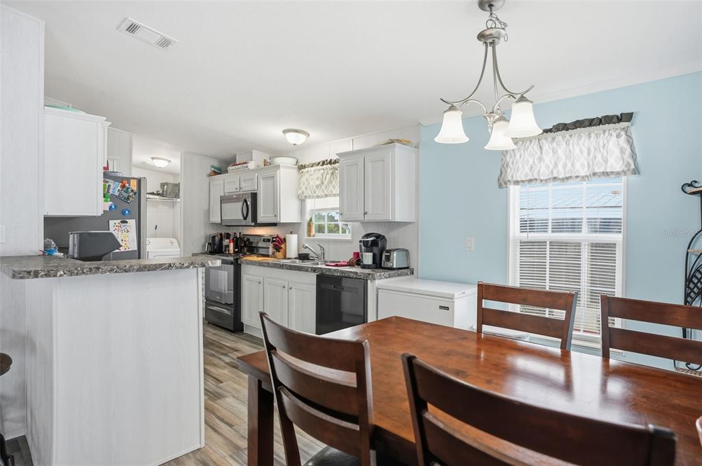 9100 Highpoint Boulevard Brooksville, FL 34613 - Photo 7 of 42 a kitchen with cabinets a counter space dining table and a sink