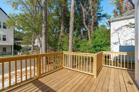 a view of a wooden deck with trees