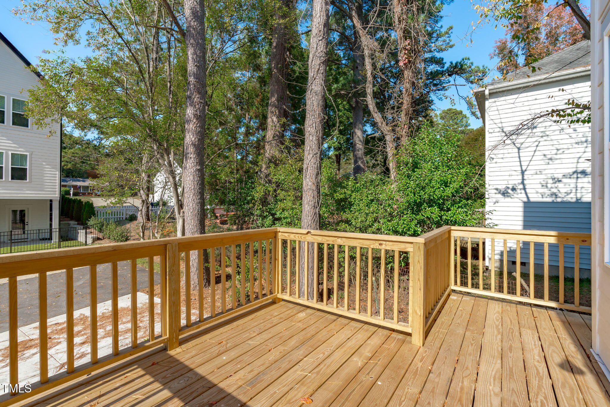5061 Lundy Drive, Unit 101 Raleigh, NC 27606 - Photo 16 of 56 a view of a wooden deck with trees