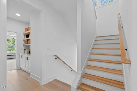 a view of entryway with wooden floor and stairs