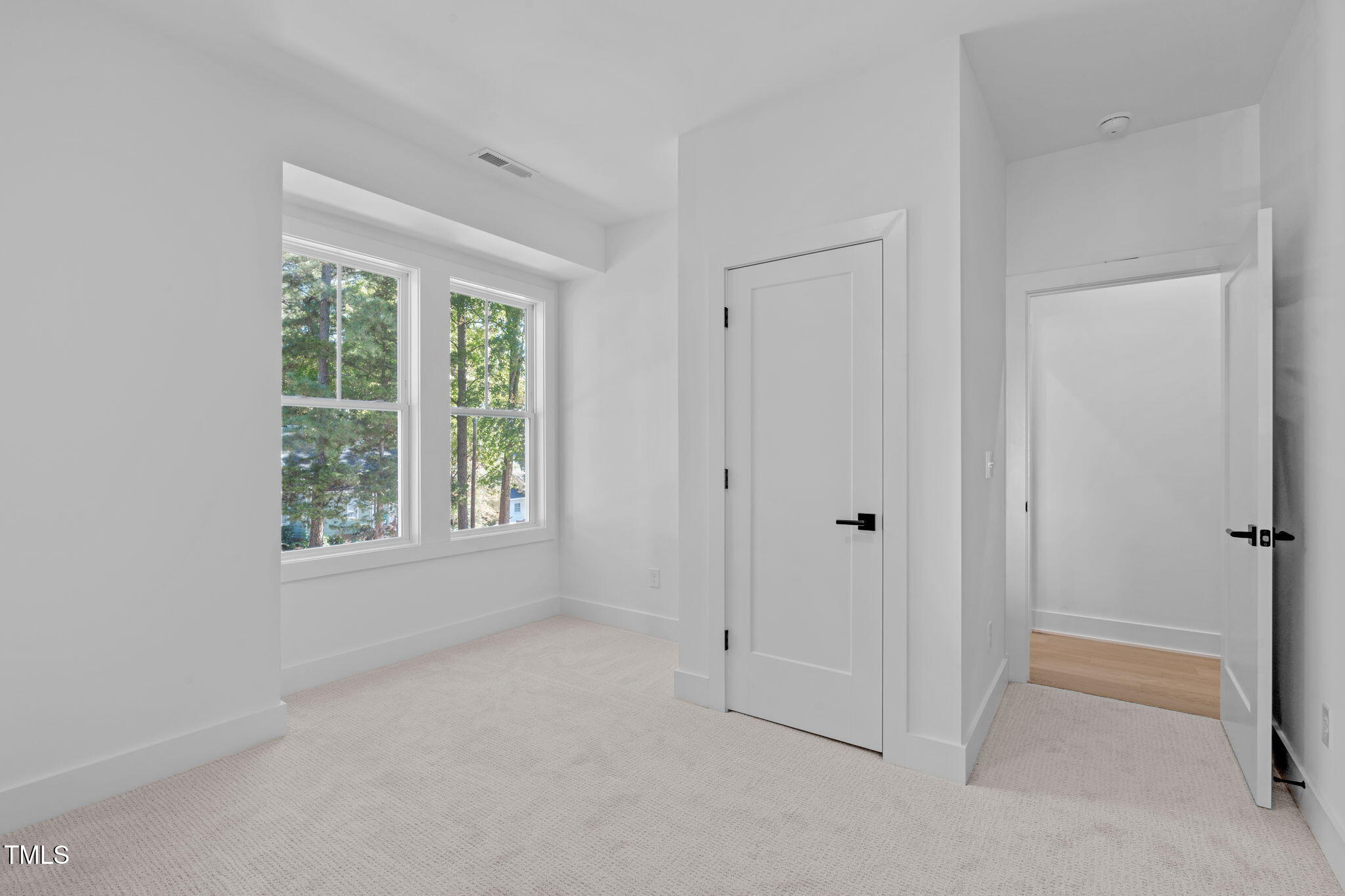 5061 Lundy Drive, Unit 101 Raleigh, NC 27606 - Photo 27 of 56 a view of an empty room with a window