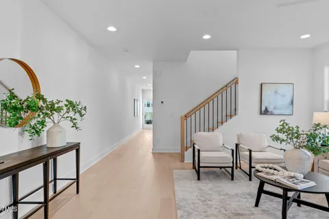 a view of an entryway with wooden floor and a potted plant