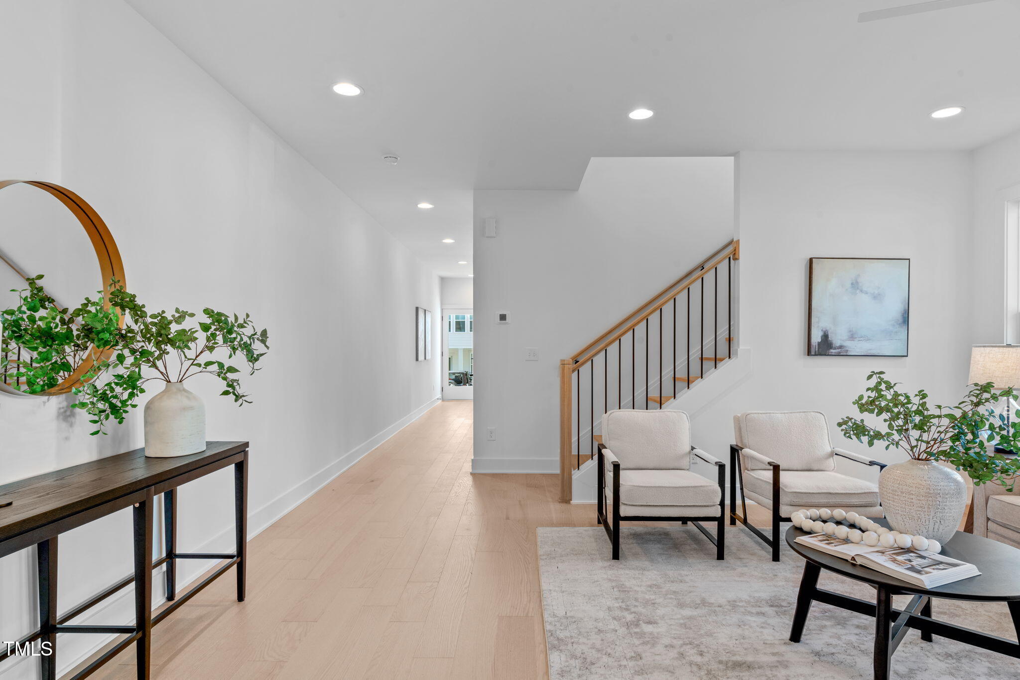 5061 Lundy Drive, Unit 101 Raleigh, NC 27606 - Photo 6 of 56 a view of an entryway with wooden floor and a potted plant