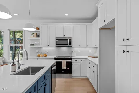 a kitchen with stainless steel appliances sink a microwave and cabinets