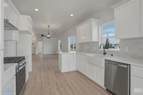 a view of a room with a window a ceiling fan and wooden floor