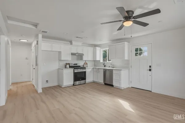 a front view of a house with a yard and trees