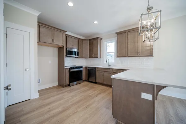 a kitchen with a refrigerator sink and cabinets