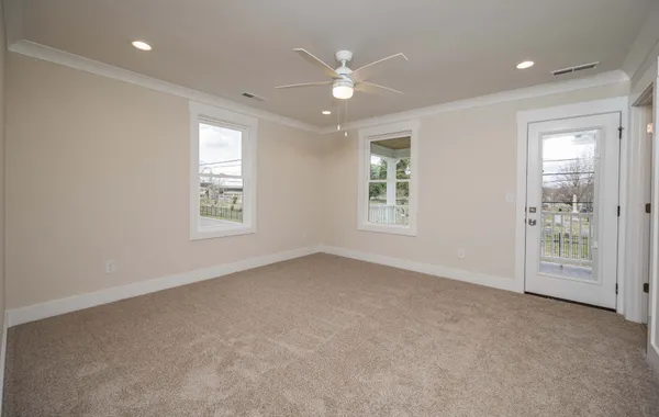 an empty room with windows and closet