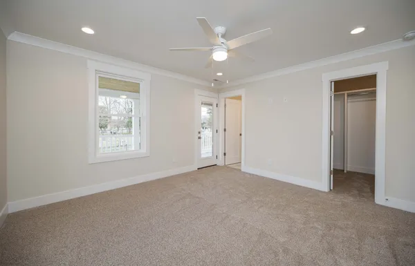 an empty room with windows and closet