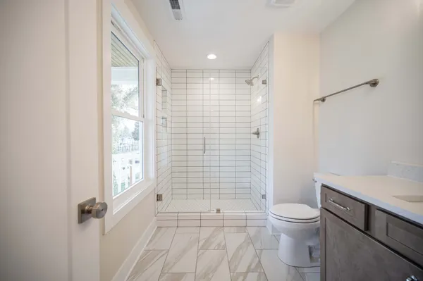 a bathroom with a toilet and a shower
