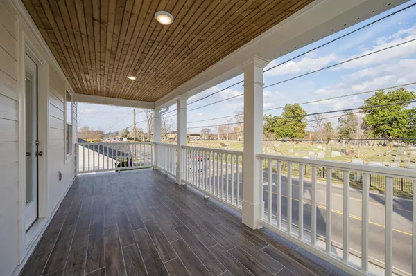 a view of a porch with wooden floor
