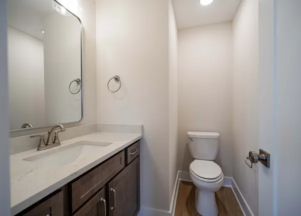a bathroom with a granite countertop sink a toilet and a mirror