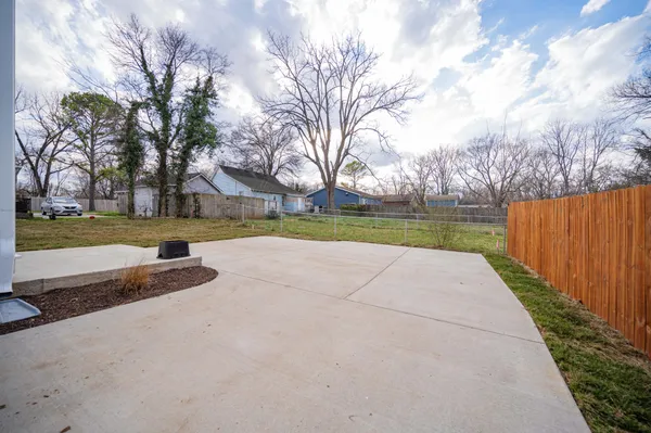 a view of swimming pool with a yard and wooden fence
