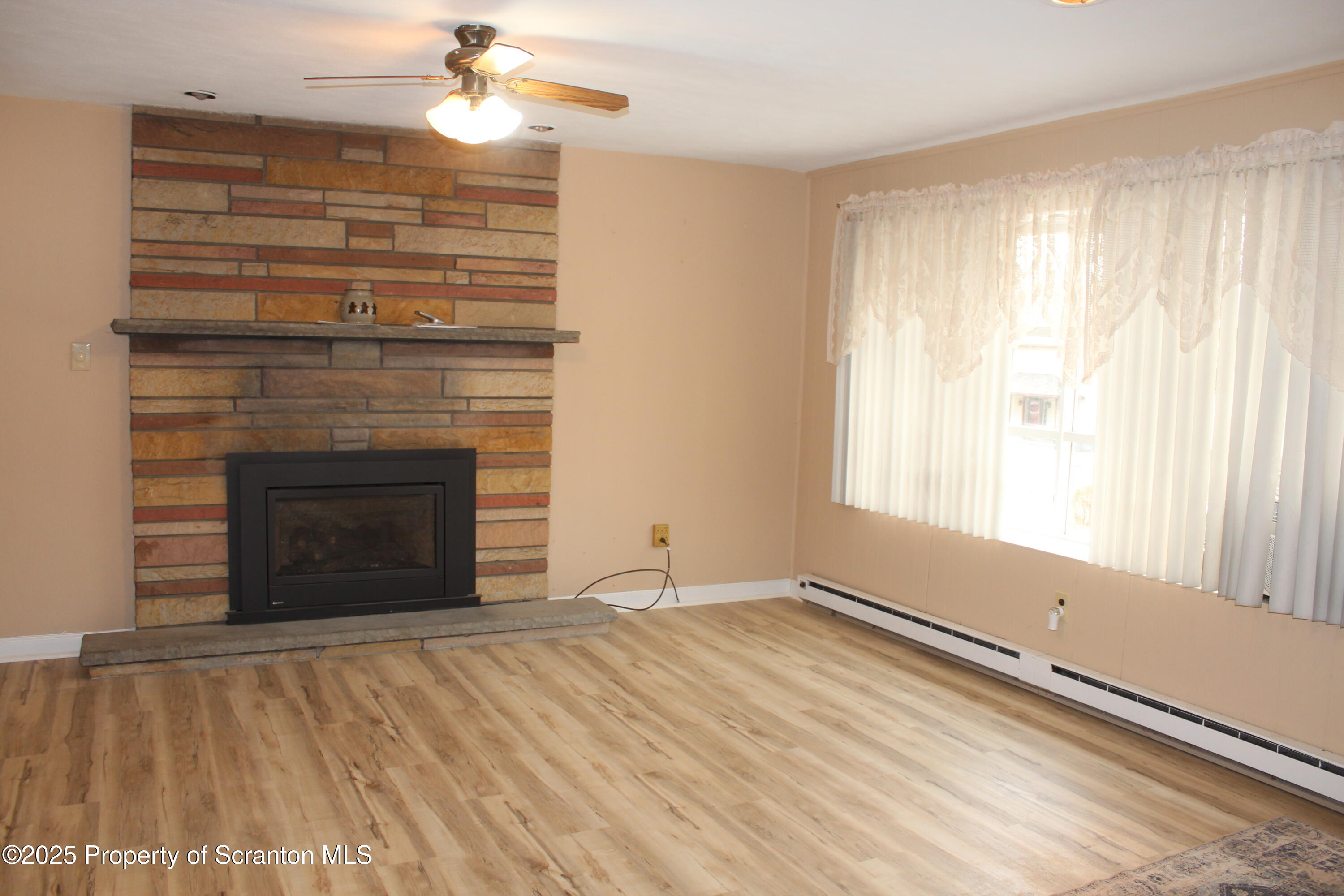 347 Terrace Avenue Shavertown, PA 18708 - Photo 13 of 59 a view of an empty room with a fireplace and a window