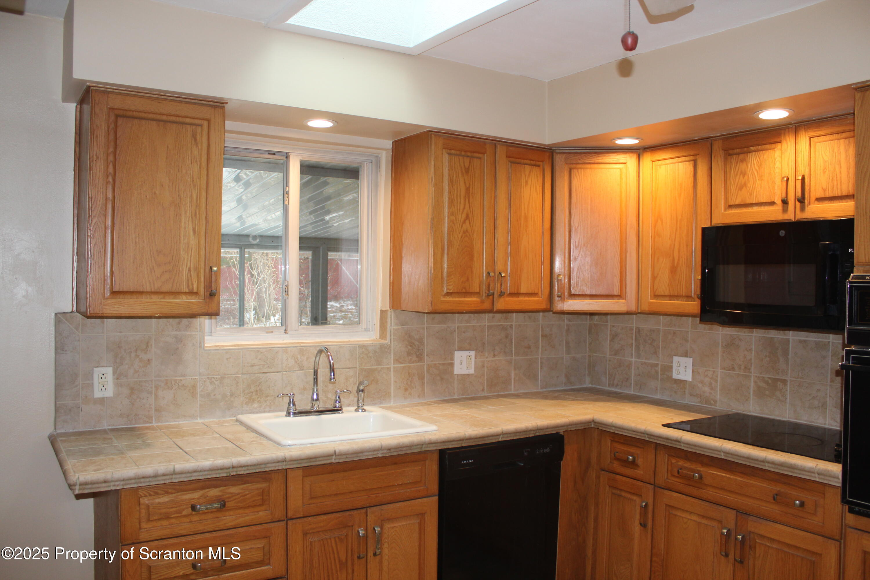 347 Terrace Avenue Shavertown, PA 18708 - Photo 18 of 59 a kitchen with stainless steel appliances granite countertop a sink and a microwave