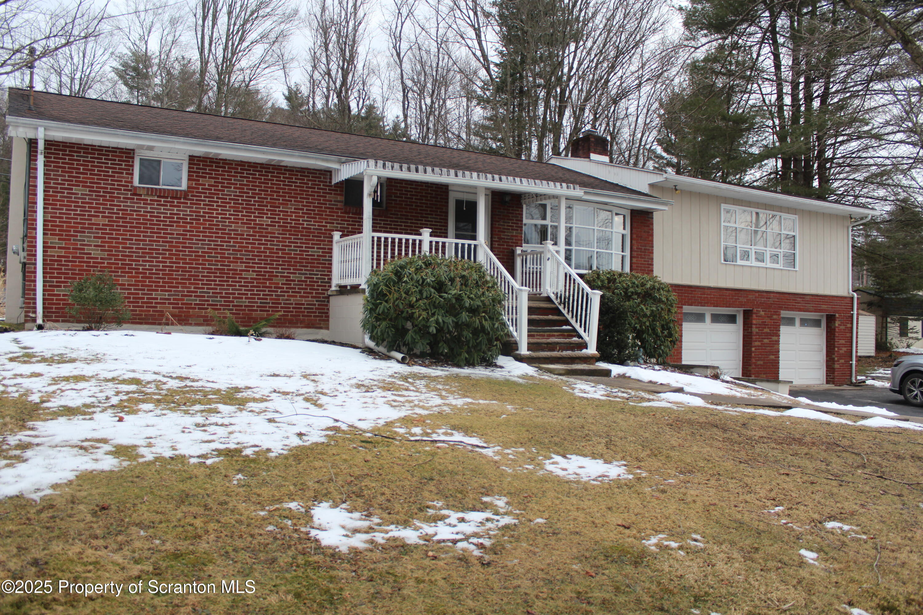 347 Terrace Avenue Shavertown, PA 18708 - Photo 5 of 59 a front view of a house with a yard covered in snow