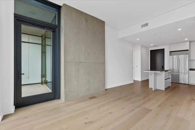 a view of an empty room and glass door