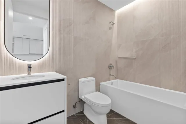 a bathroom with a toilet a sink and bathtub