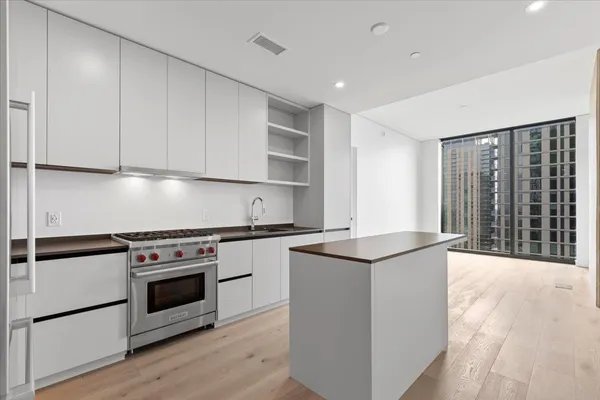 a kitchen with granite countertop a stove and a sink