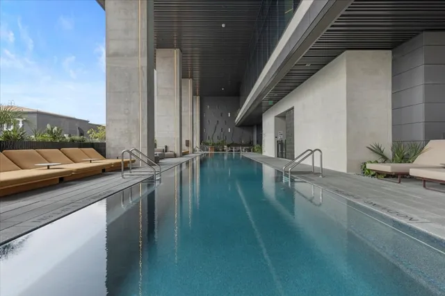 a patio with glass top table and chairs