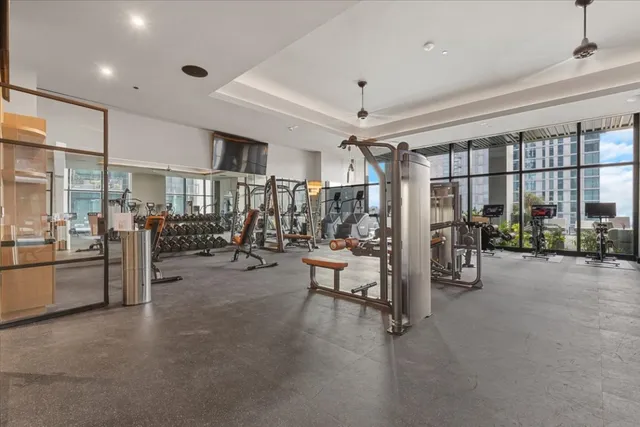 a view of a gym room with lots of gym equipment
