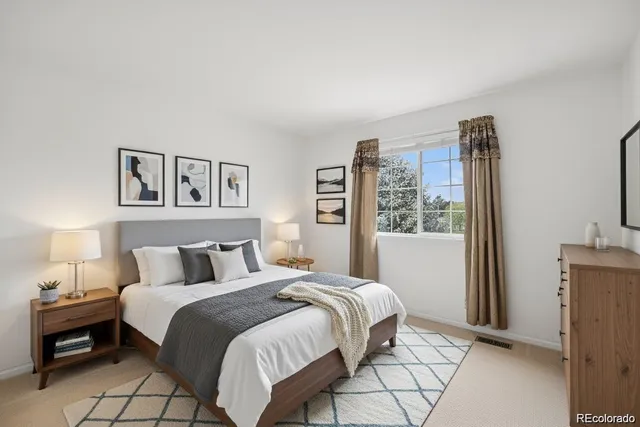 a bedroom with a large bed and a window