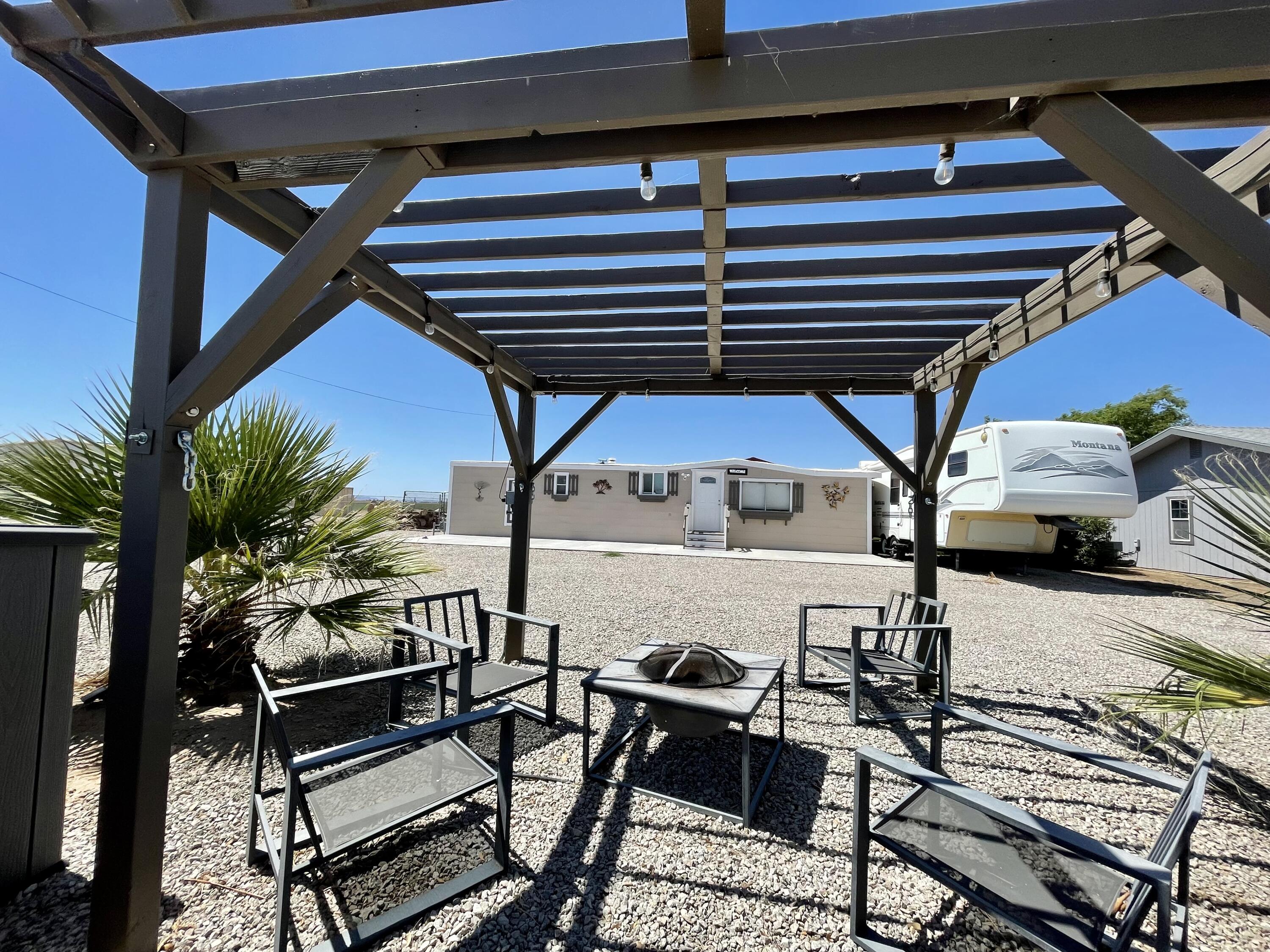 a view of a patio with table and chairs under an umbrella